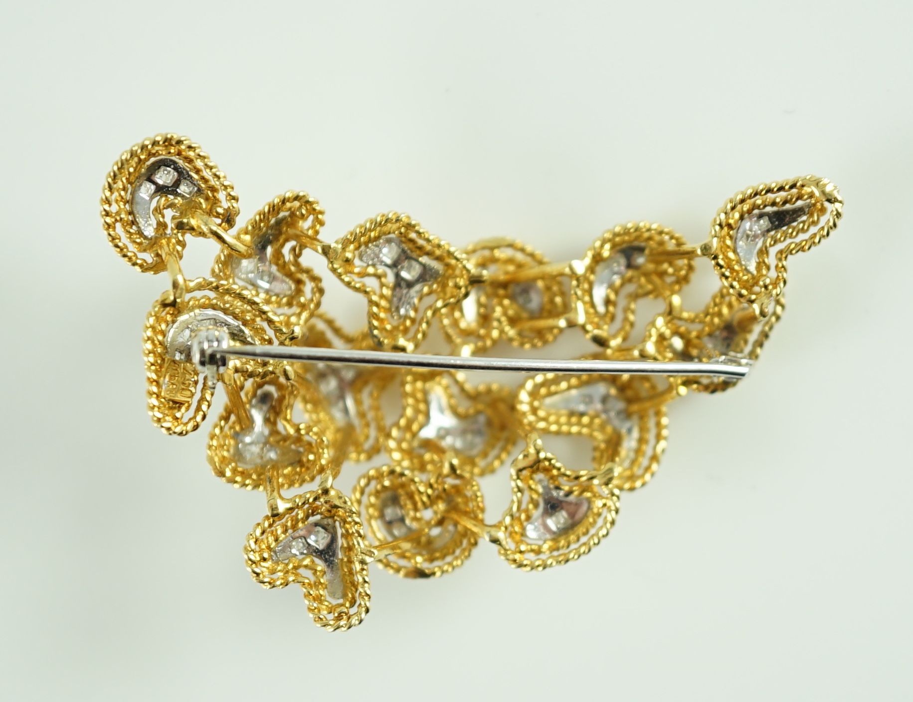 A modern stylish Italian 750 gold and diamond chip set modernist brooch